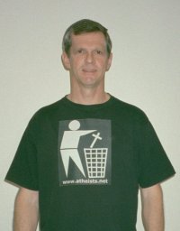 Darwin Bedford wearing a T-shirt depicting the international symbol for a wastes container with a religious cross in place of the wastes. 